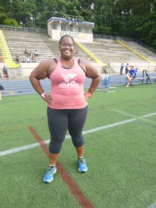 woman runner standing on field at track